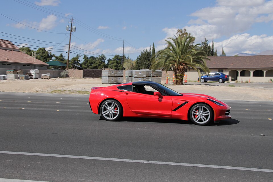 Red Chevrolet Corvette C7 Stingray on a desert road